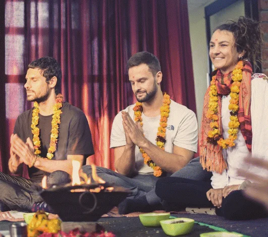 Students at a fire ritual in the yoga hall at Avatar Yoga School