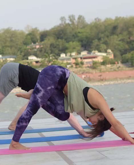 Yoga class by the Ganga during teacher training in Rishikesh