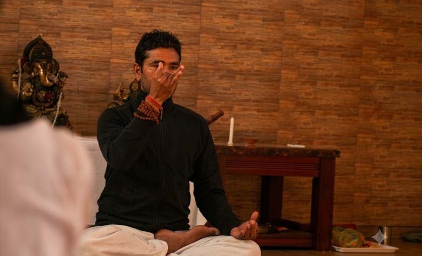Yoga teacher guiding a student during the 200 hour course