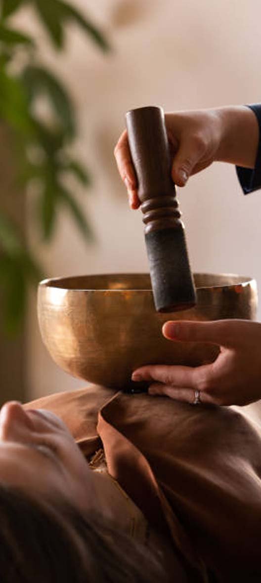 Students learning sound healing with singing bowls at Avatar Yoga School in Rishikesh